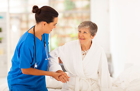 Nurse in blue scrubs providing home health care in Baltimore.